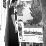 Joan Szukalski in doorway with dog